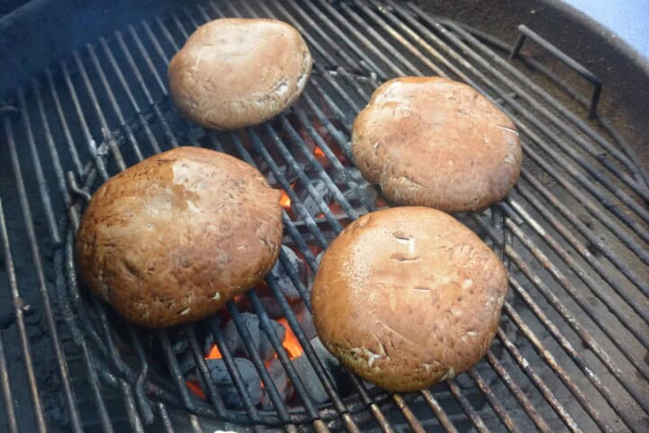 Four Portobello mushrooms on a grill