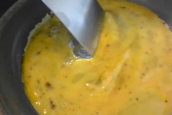 A pan with eggs and a spatula