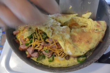 An omelet with ham, cheese and vegetables