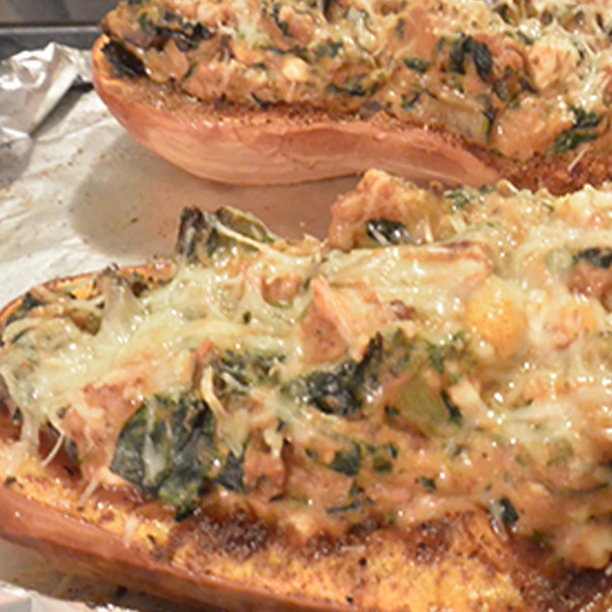 Stuffed butternut squash with turkey, topped with cheese