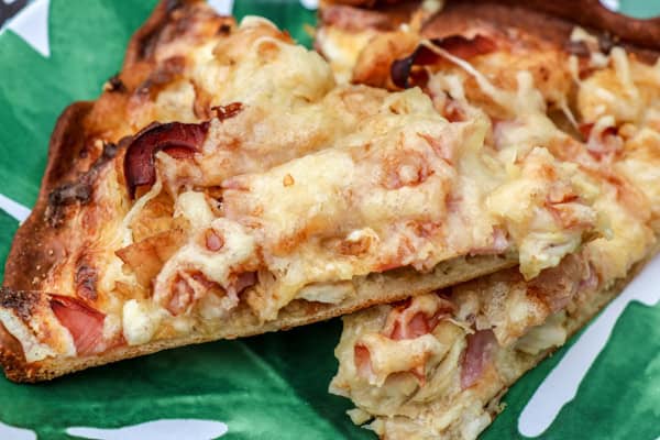 Two slices of pizza on a green plate