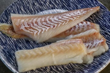 Fish fillets on a blue and white plate