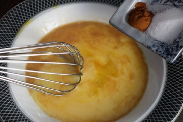 Eggs with whisk and sauce