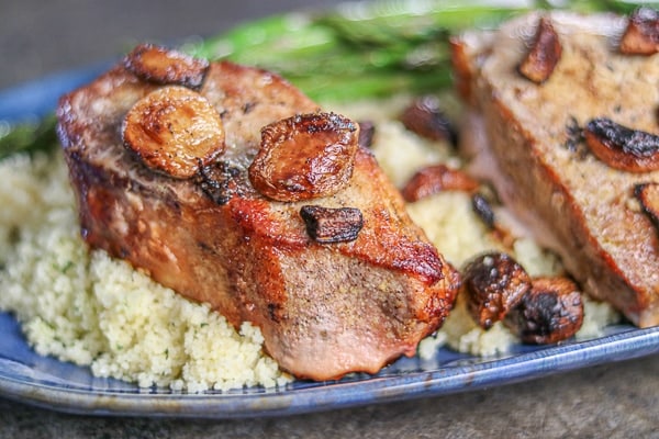 Two pieces of pork chops with asparagus on a plate
