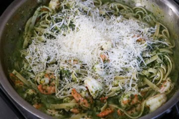 A pan filled with pasta and shrimp