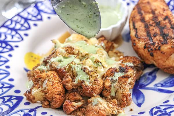 The cauliflower is served with a sauce and chicken