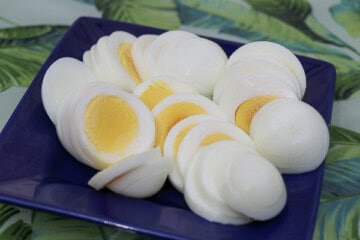A blue plate with sliced hard boiled eggs