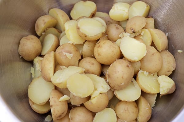 Potatoes in a bowl with a knife and a knife