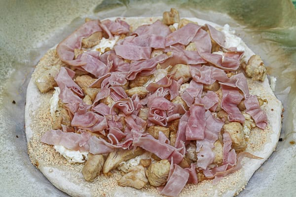 A pizza with ham and cheese