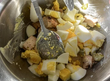 A bowl filled with eggs, meat and other ingredients