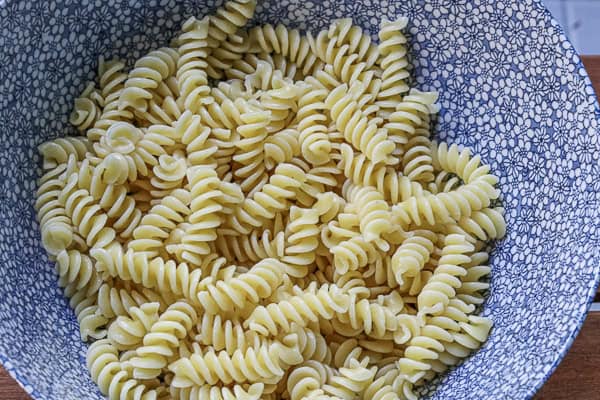 A bowl of pasta on a wooden table