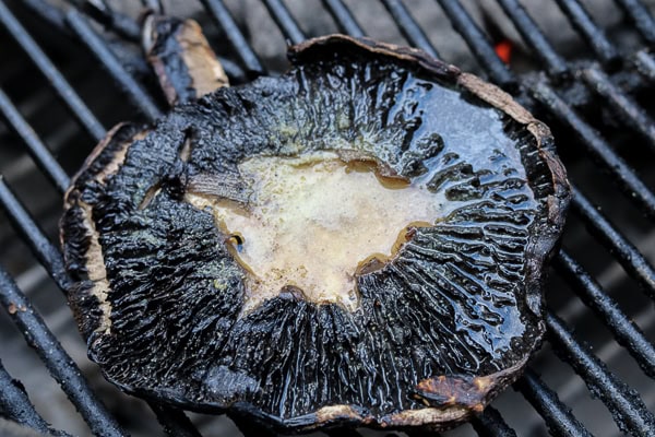 A mushroom is being cooked on a grill