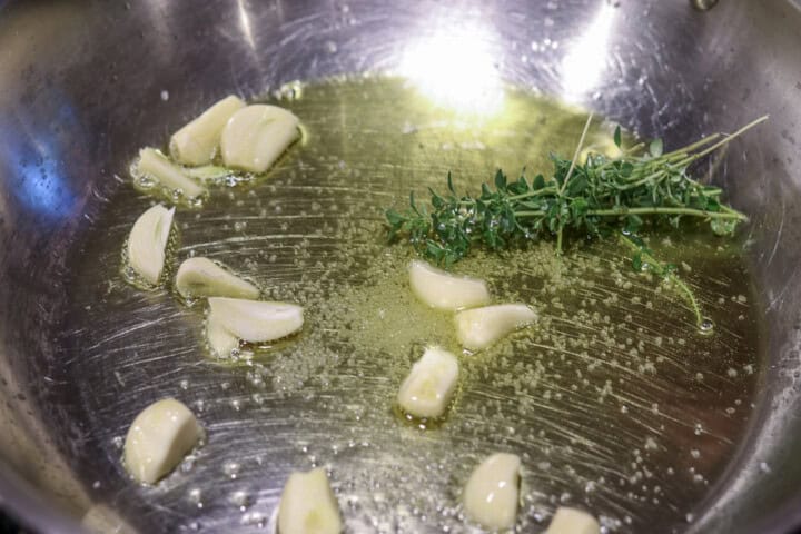 Herbs and garlic with olive oil in pan