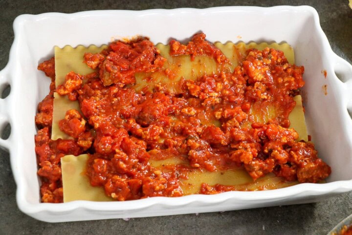 Sauce added to top of lasagns