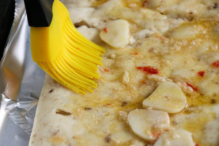 Flat Bread Pizza  with olive oil sauce spread on with brush