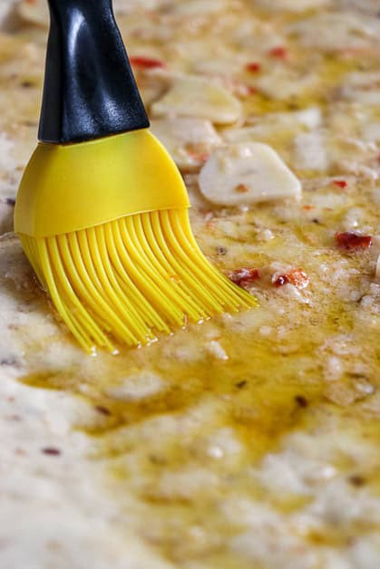 Flat Bread Pizza  with olive oil sauce spread on with brush