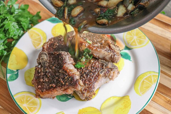Garlic and sauce poured over lamb chops