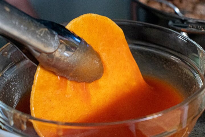 Tortilla chips dipped in sauce