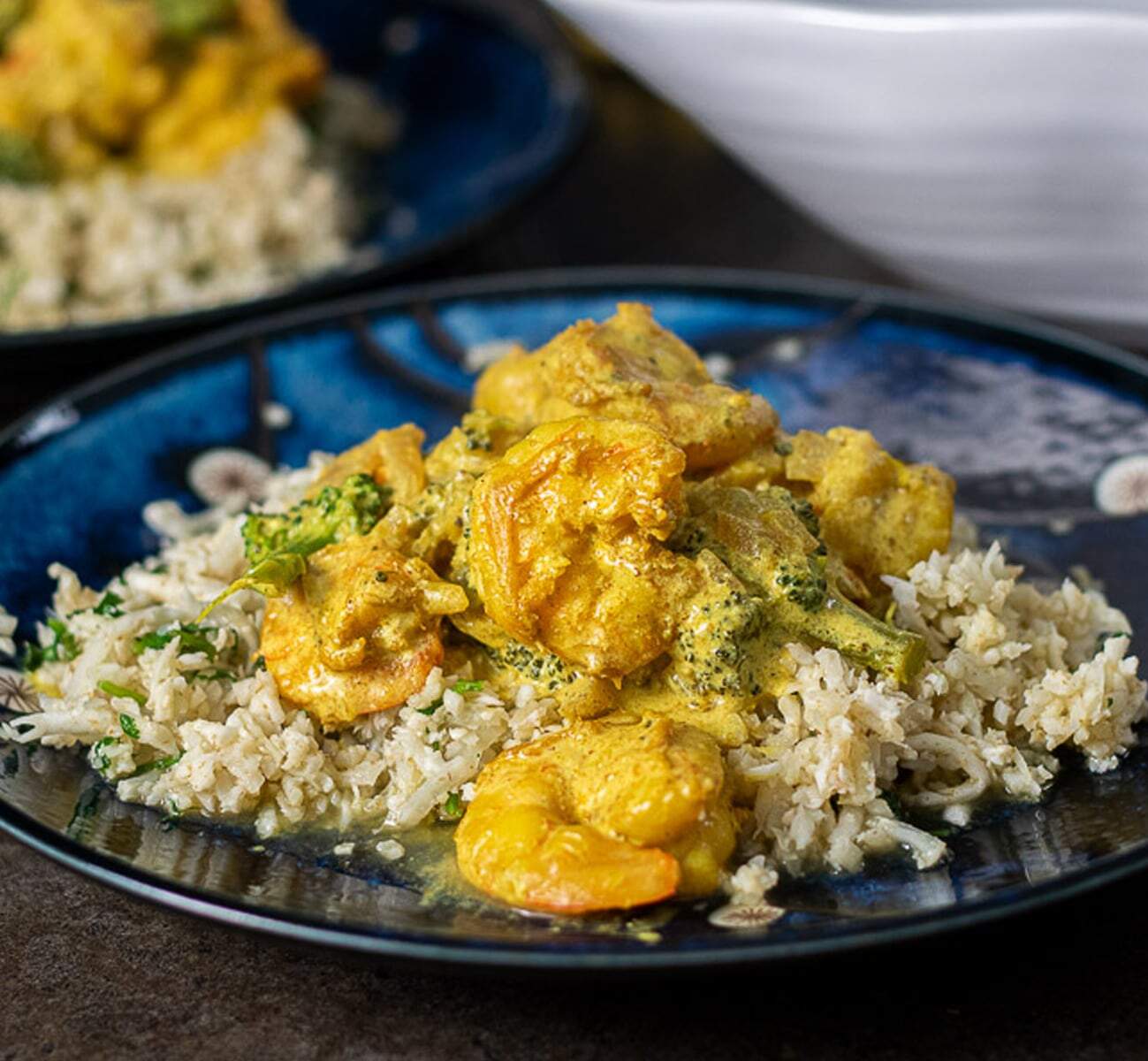 Shrimp curry and rice on a blue plate