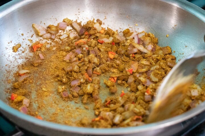 Water pouring in a pan with onions