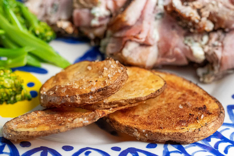 Sliced Potatoes on a plate with a pork chop