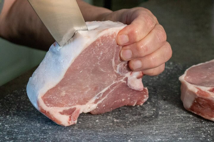 cutting the middle of the pork chop