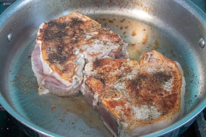 Seared pork chops in a pan