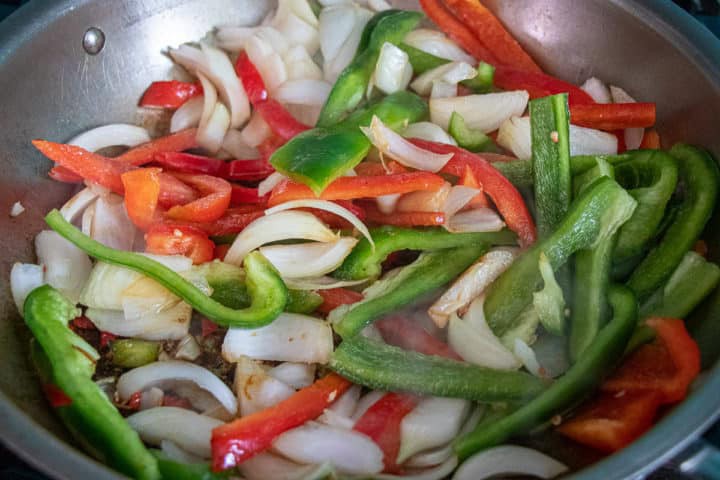 A pan with peppers, onions and other vegetables