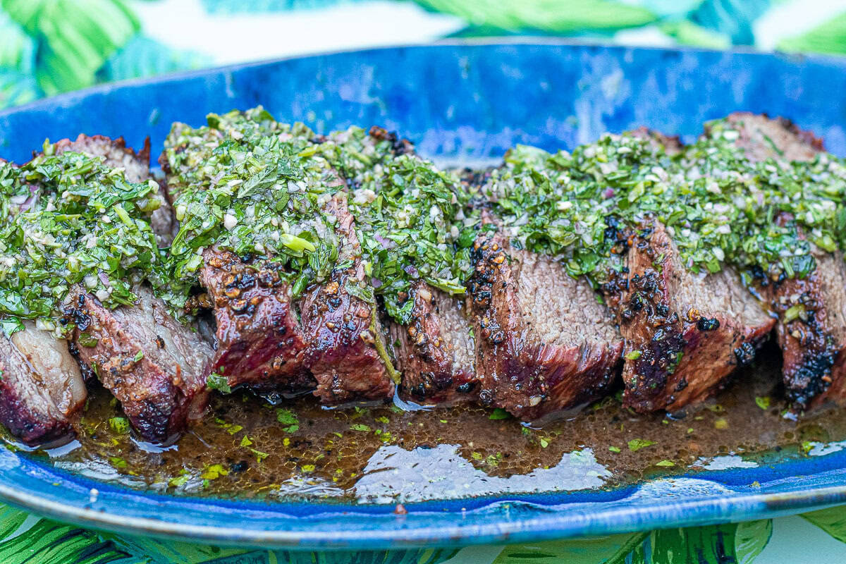 Steak with Chimichurri Sauce on a blue plate