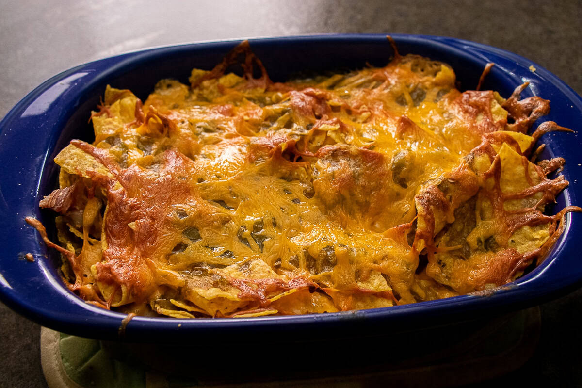 Tortilla Chips, Cheese, and Chicken Casserole topped with melted cheese