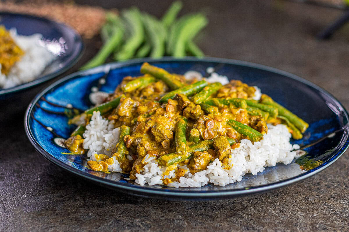Beef and Lentil Curry on Rice with a blue plate