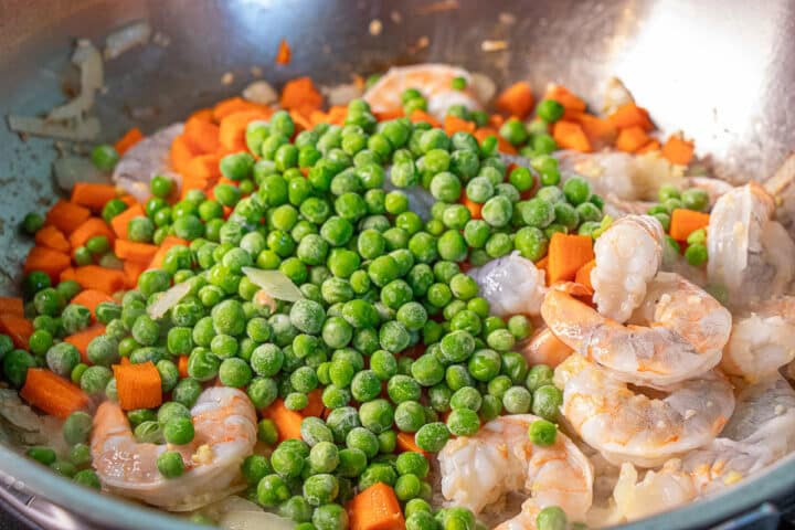 Peas, carrots and shrimp in a pan