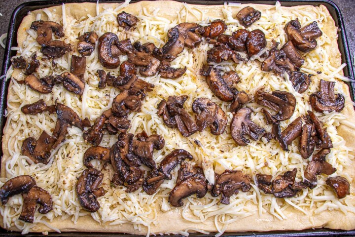 Mushrooms on top of pizza and cheese