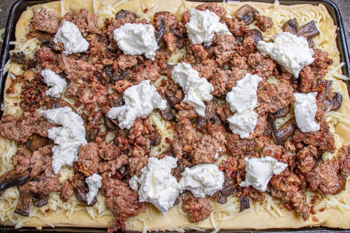 Mushrooms on top of pizza and cheese