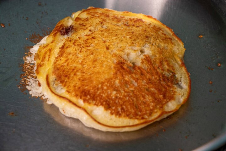 Chocolate chips in a batter in a frying pan