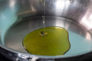 A pan with olive oil being poured into it