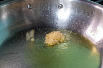 A pan with olive oil and garlic