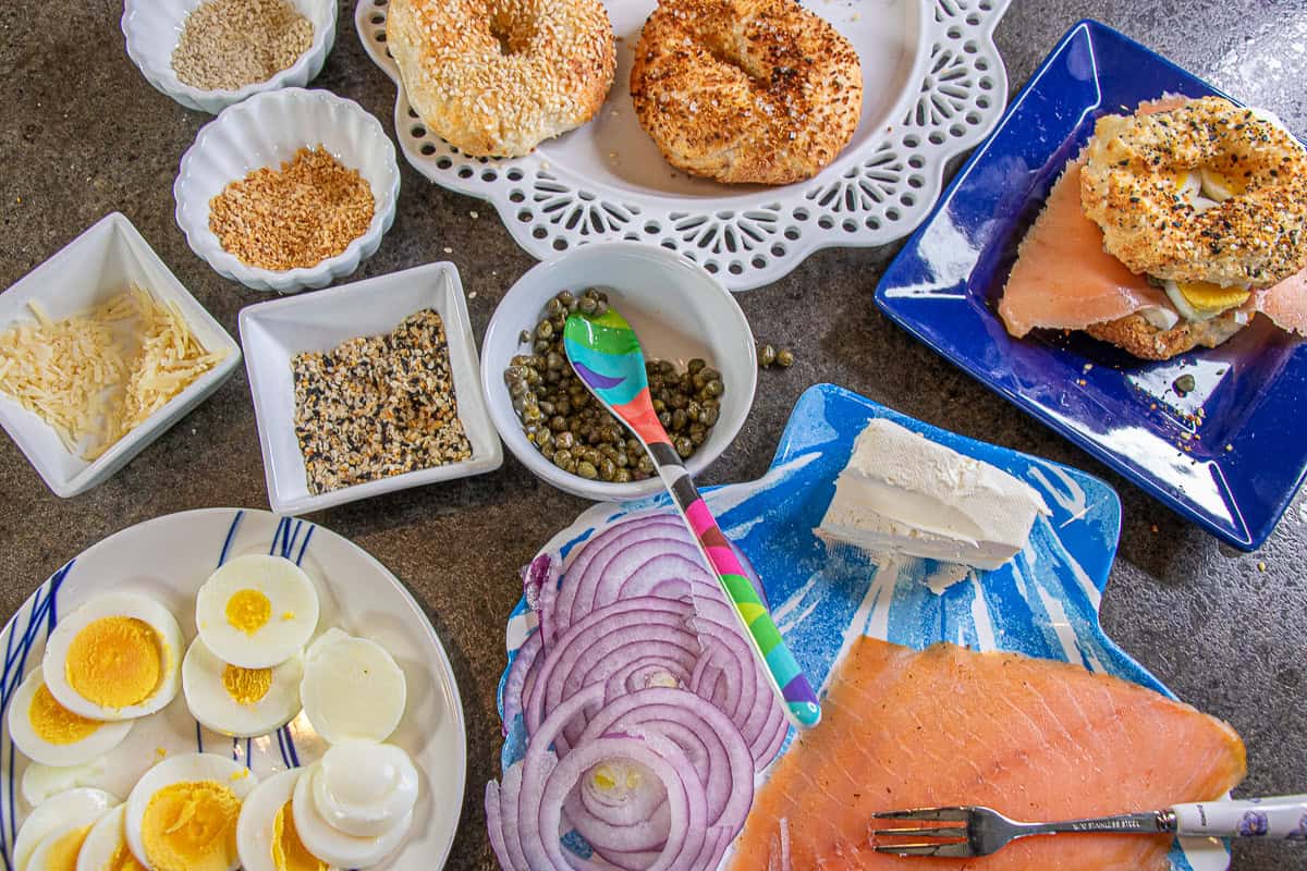 Bagels, onions, salmon, eggs spices, and cream cheese