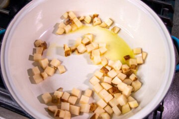 Cut up potatoes in sauce pan