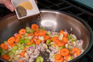 Spices bining added to carros, onions and celery