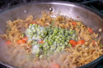 Frozen Pean in pan with noodles and veggie
