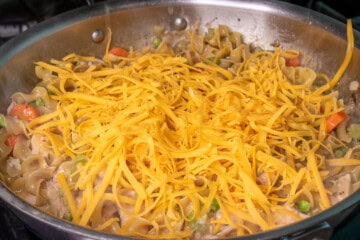 Shredded Cheese in a pan with tuna noodle helper