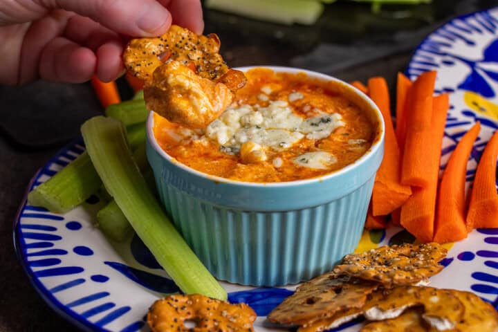 Chicken Buffalo dip with flat pretzels in a ramiken