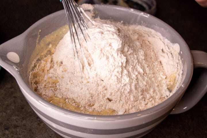 Flour added to banana mixture in a bowl