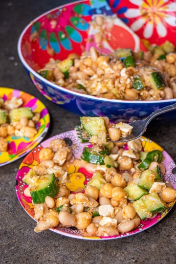 Bean salad in serving bowl and plates
