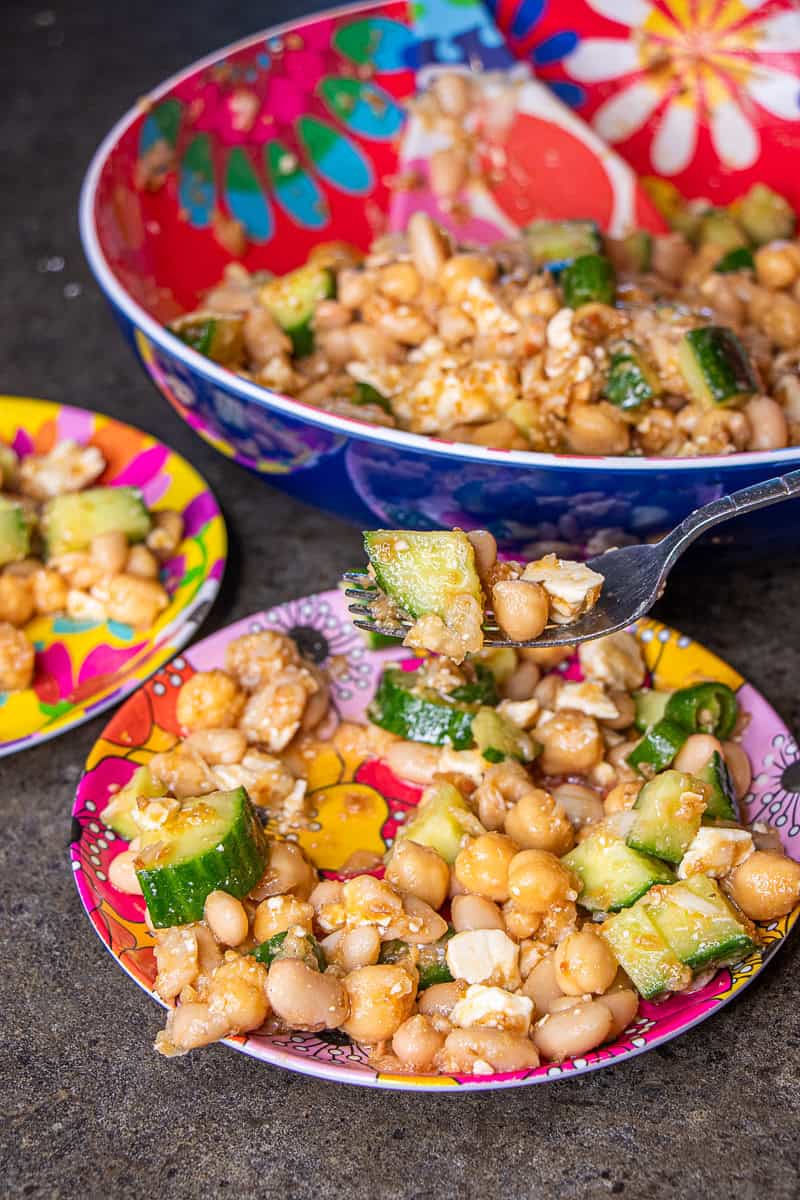 Bean salad in serving bowl and plates