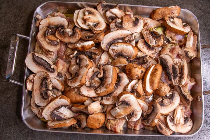 Chicken and sliced Mushrooms in a roasting pan